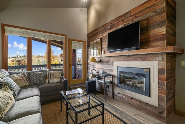 living room featuring wood-type flooring and vaulted ceiling