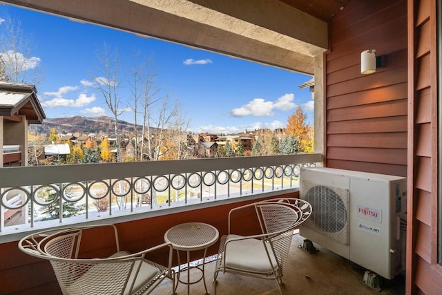 balcony featuring a mountain view and ac unit