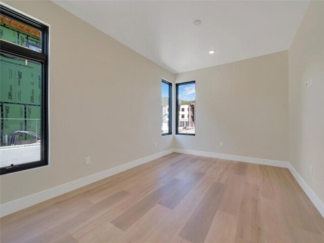 spare room featuring light hardwood / wood-style floors