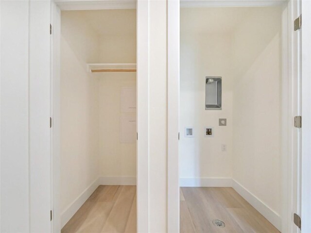 laundry area featuring washer hookup and light hardwood / wood-style flooring