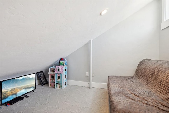 playroom with vaulted ceiling, a textured ceiling, and baseboards