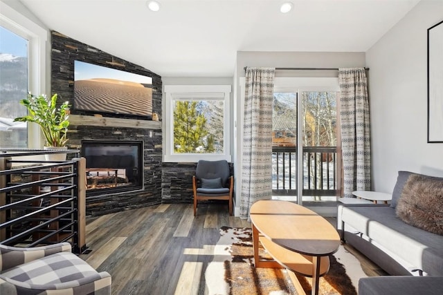 living room with a fireplace, wood finished floors, and recessed lighting