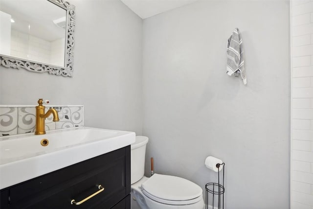 full bath featuring toilet and vanity