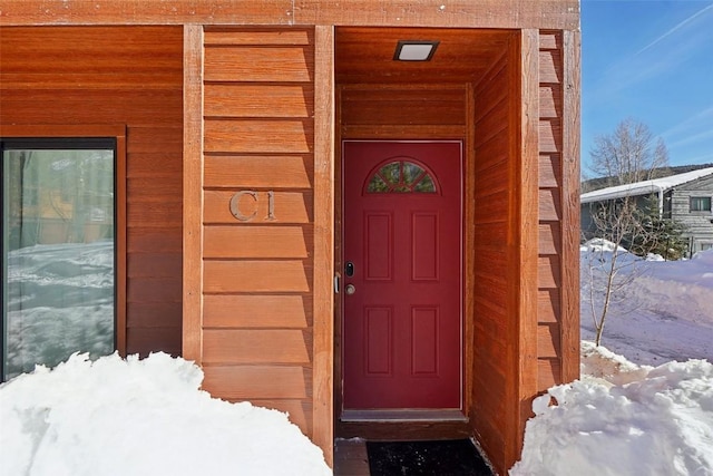 view of snow covered property entrance