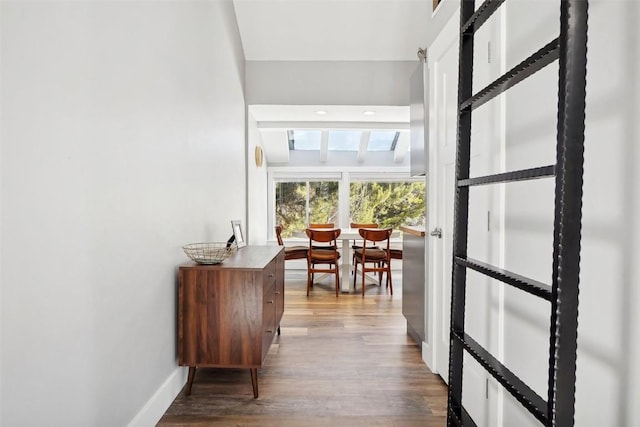 interior space with baseboards and wood finished floors