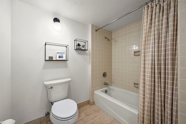 bathroom featuring shower / bath combo, baseboards, toilet, and tile patterned floors