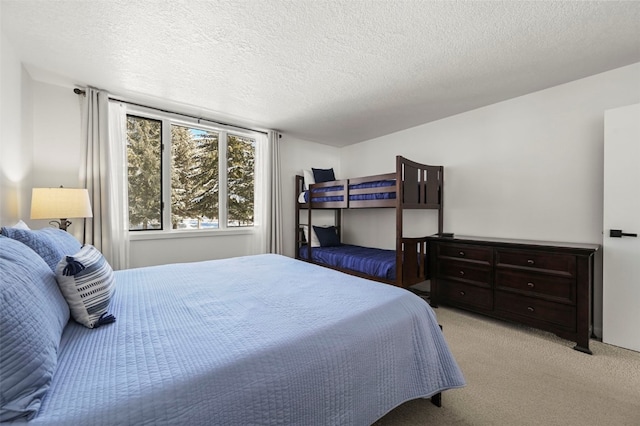 bedroom with carpet and a textured ceiling