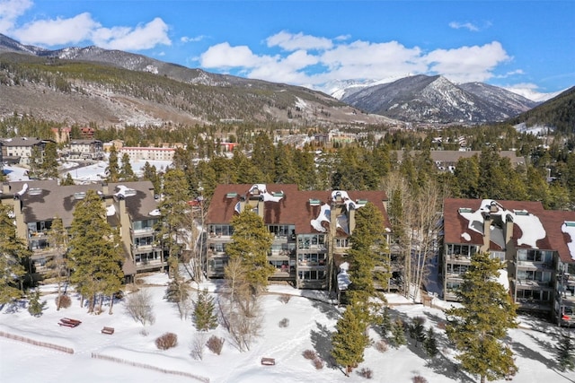 snowy aerial view with a residential view and a mountain view