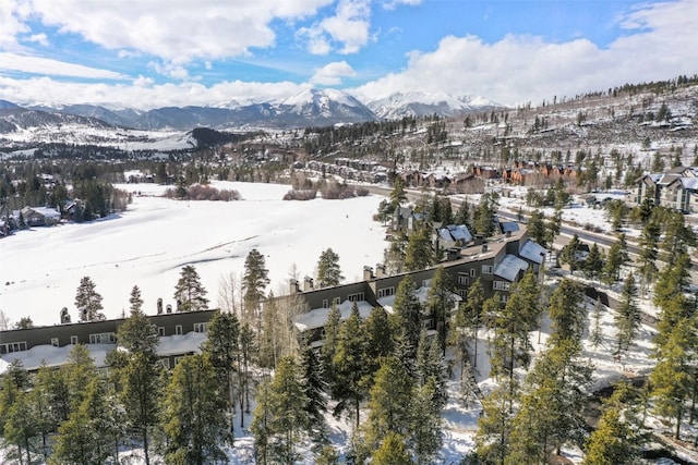 snowy aerial view with a mountain view