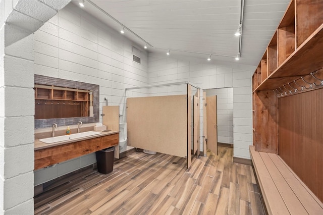 full bath featuring lofted ceiling, toilet, a stall shower, vanity, and wood finished floors