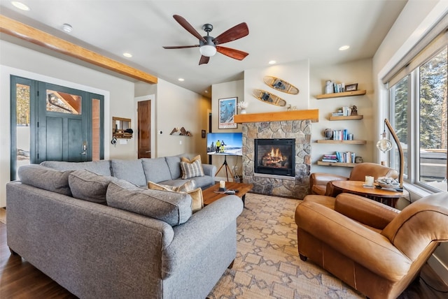 living area with recessed lighting, a fireplace, beamed ceiling, and ceiling fan