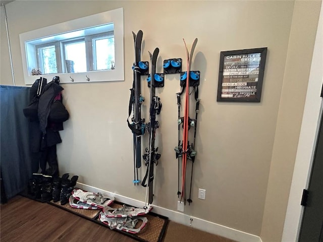 interior space with baseboards and wood finished floors