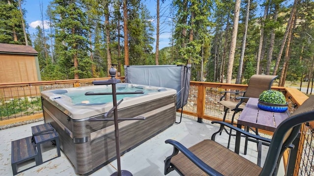 wooden deck featuring a hot tub