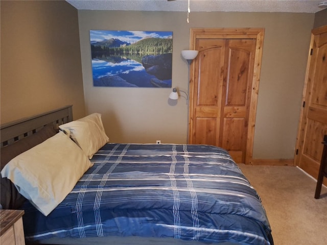 bedroom featuring carpet floors and a textured ceiling