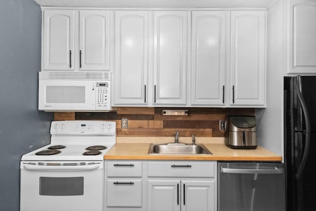 kitchen with white cabinetry, white appliances, and sink