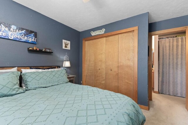 carpeted bedroom featuring a closet