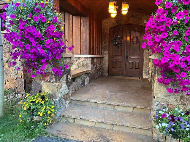 property entrance featuring stone siding