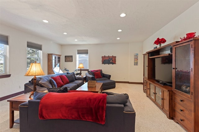 living area featuring light carpet, baseboards, a textured ceiling, and recessed lighting