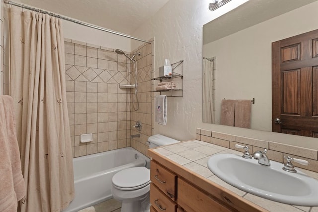 full bathroom featuring shower / bath combination with curtain, a textured wall, vanity, and toilet