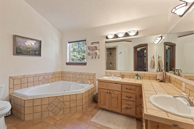 bathroom featuring a bath, a tile shower, a sink, and lofted ceiling