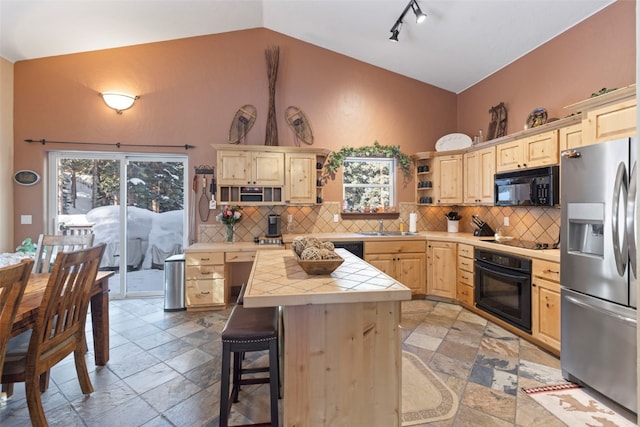 kitchen featuring open shelves, tile counters, backsplash, light brown cabinets, and black appliances