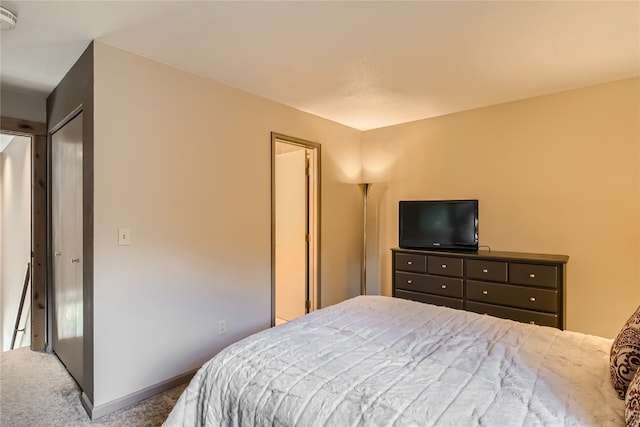 bedroom with carpet and a closet