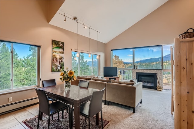 dining space featuring light tile patterned floors, track lighting, high vaulted ceiling, and a baseboard heating unit