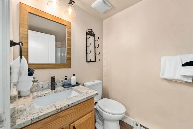 bathroom featuring vanity, a baseboard radiator, and toilet