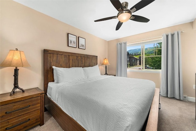 bedroom featuring light carpet and ceiling fan