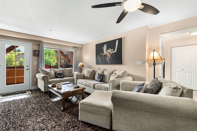 living room with ceiling fan and wood-type flooring