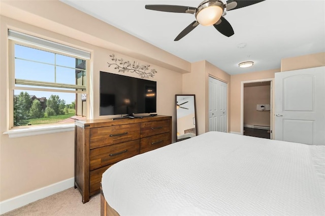 carpeted bedroom featuring ceiling fan and a closet