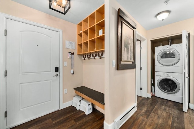 clothes washing area featuring dark hardwood / wood-style floors, stacked washer / dryer, and a baseboard heating unit