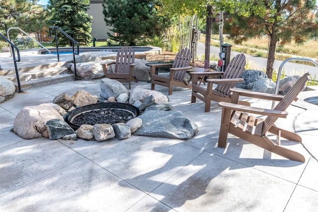 view of patio / terrace featuring an outdoor fire pit