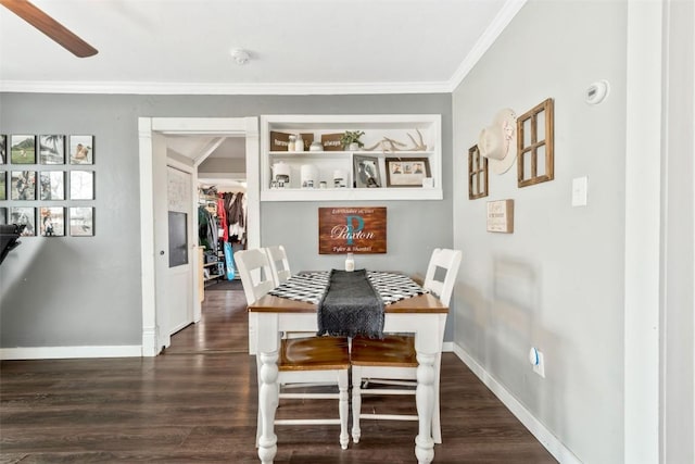 dining room with baseboards, ornamental molding, ceiling fan, and dark wood-style flooring