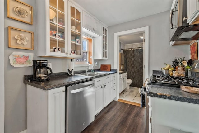 kitchen featuring dark countertops, white cabinetry, and stainless steel appliances