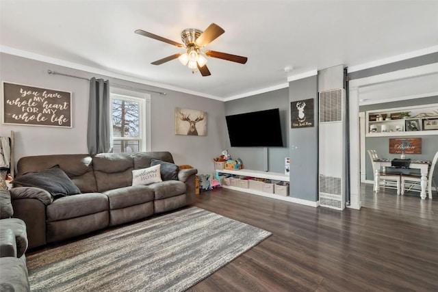 living room with ornamental molding, ceiling fan, and wood finished floors