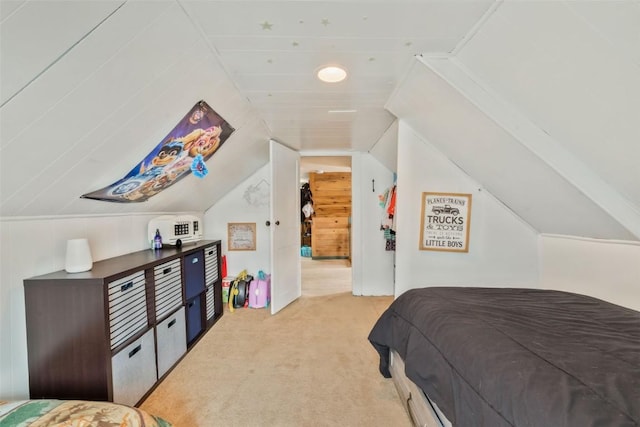 bedroom featuring lofted ceiling and light colored carpet