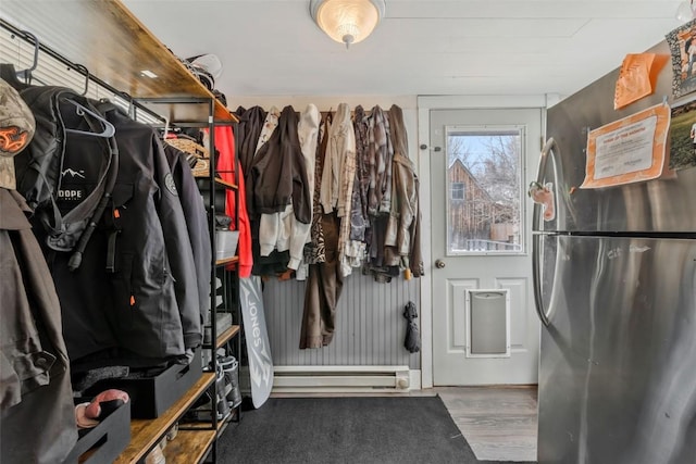 interior space featuring baseboard heating and wood finished floors