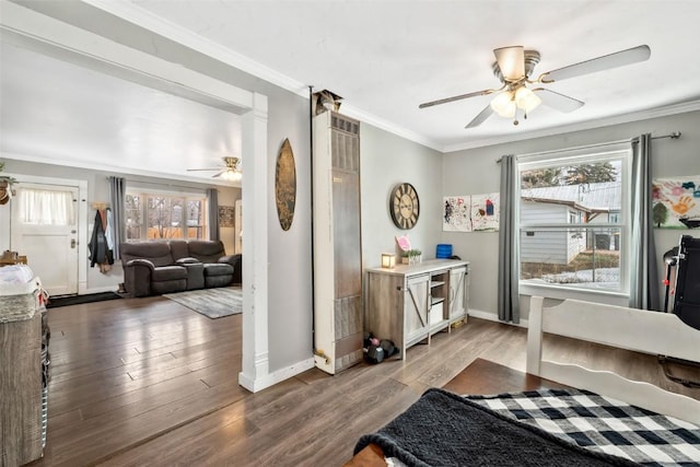 bedroom with baseboards, ornamental molding, ceiling fan, and wood finished floors