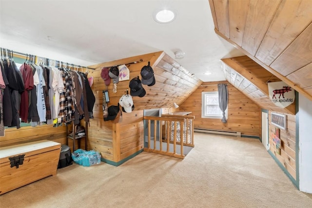 bonus room featuring a baseboard heating unit, wood walls, carpet, and lofted ceiling