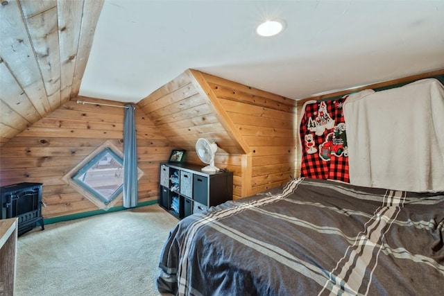 carpeted bedroom with wood walls and vaulted ceiling