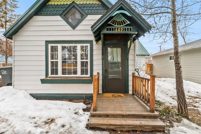 view of snow covered property entrance