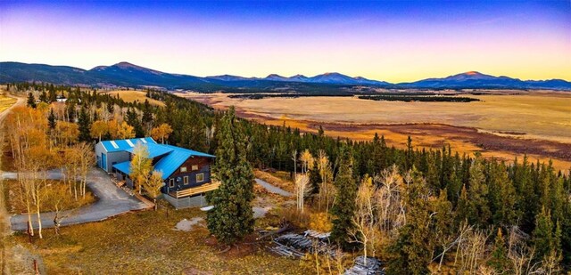 aerial view at dusk featuring a mountain view