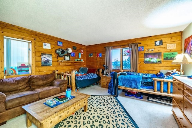 carpeted bedroom featuring a textured ceiling and wooden walls