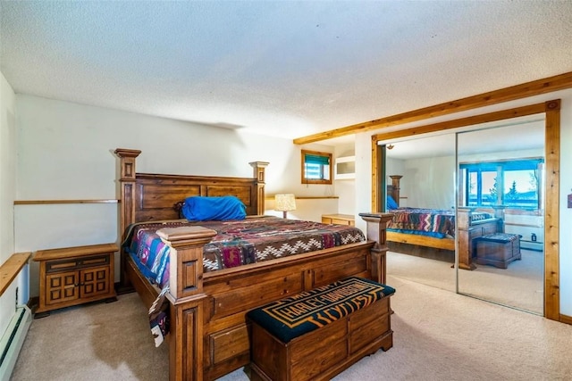 carpeted bedroom featuring baseboard heating, a closet, and a textured ceiling