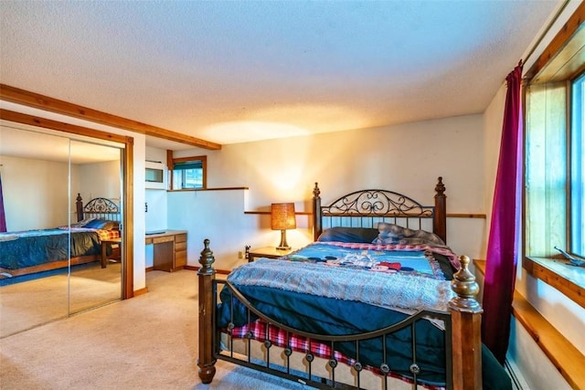 bedroom with carpet flooring, a closet, and a textured ceiling