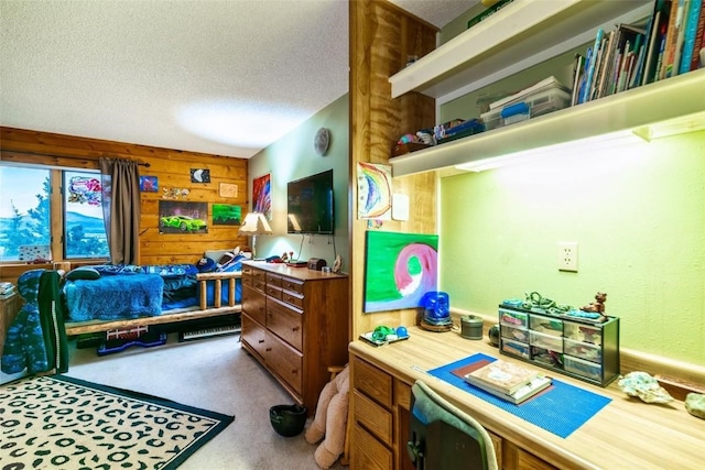 bedroom featuring wood walls, carpet floors, and a textured ceiling