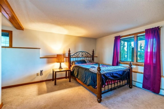 bedroom with beam ceiling, carpet floors, and multiple windows