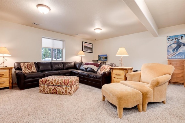 carpeted living room with beam ceiling