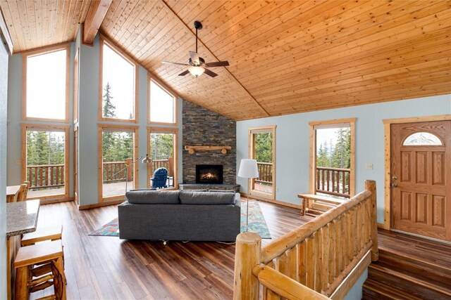 living room with high vaulted ceiling, dark hardwood / wood-style floors, ceiling fan, a fireplace, and beamed ceiling